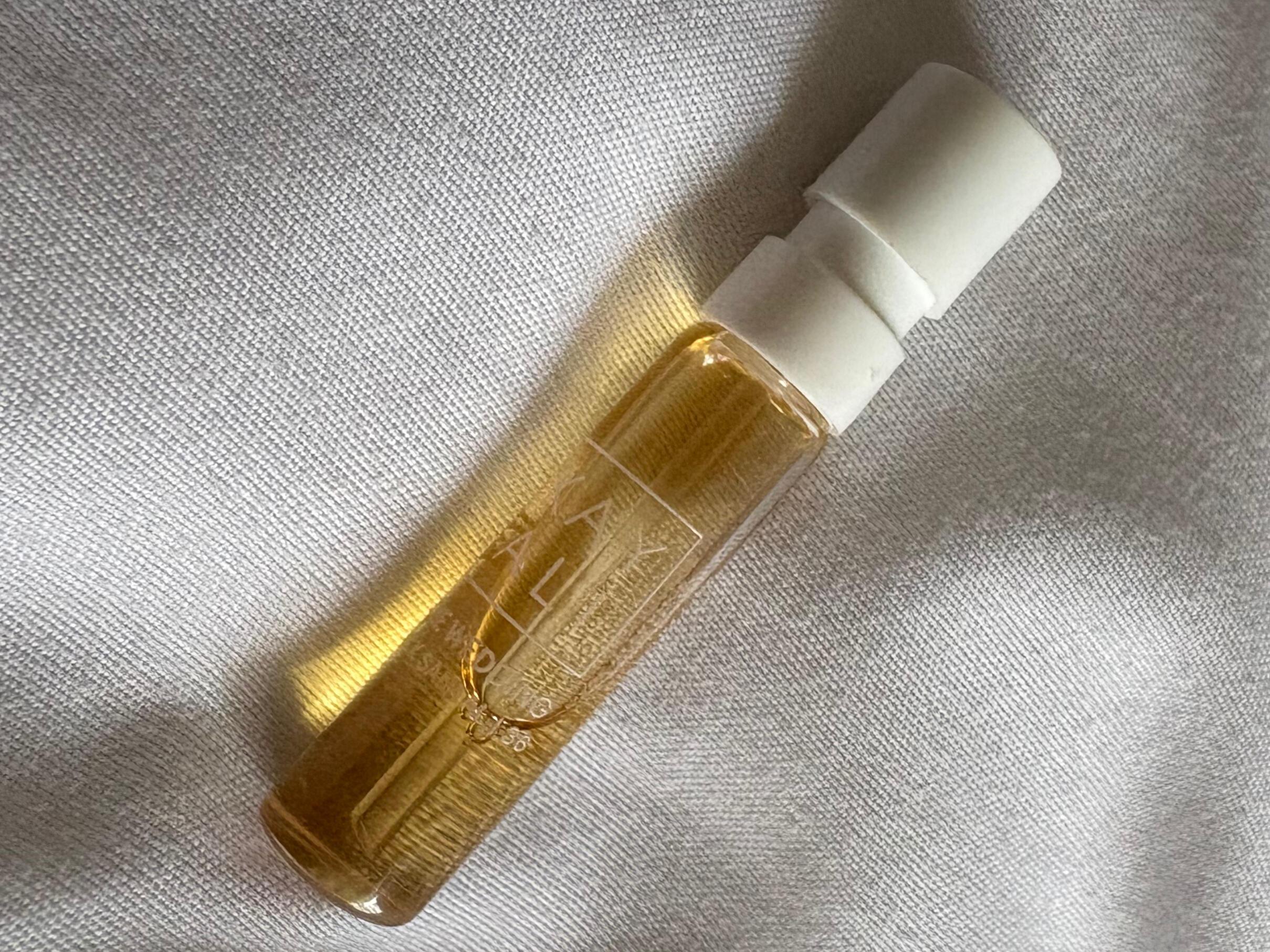 A photo of the 1.5ml tester perfume from kayali labeled the wedding (silk santal) on a white background. The liquid inside is golden in color.